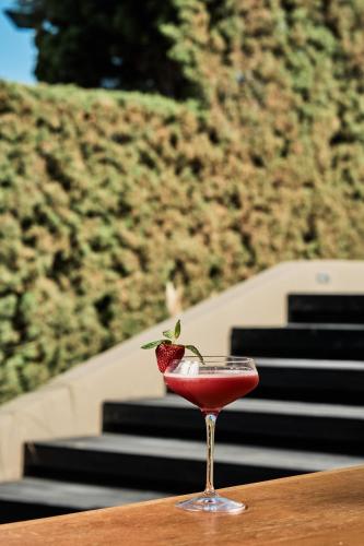 a glass with a strawberry in it sitting on a table at NEMA Design Hotel & Spa - Adults Only in Hersonissos