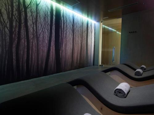 a room with two beds and a window with trees at NEMA Design Hotel & Spa - Adults Only in Hersonissos