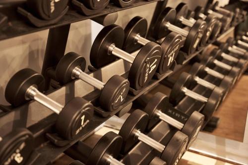 a row of dumbbells in a gym at NEMA Design Hotel & Spa - Adults Only in Hersonissos