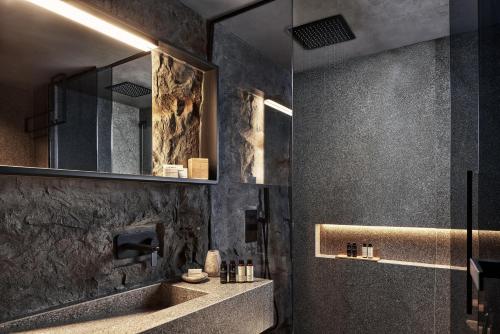 a bathroom with a sink and a mirror at NEMA Design Hotel & Spa - Adults Only in Hersonissos