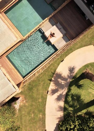 an overhead view of a woman in a swimming pool at NEMA Design Hotel & Spa - Adults Only in Hersonissos