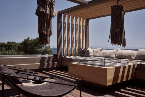 a living room with a couch and a coffee table at NEMA Design Hotel & Spa - Adults Only in Hersonissos