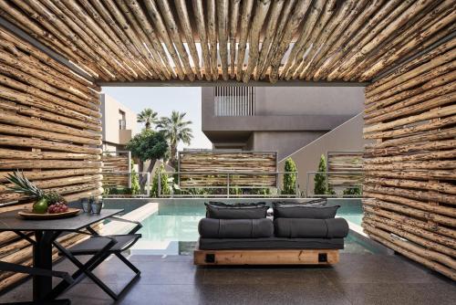 a living room with a couch next to a pool at NEMA Design Hotel & Spa - Adults Only in Hersonissos