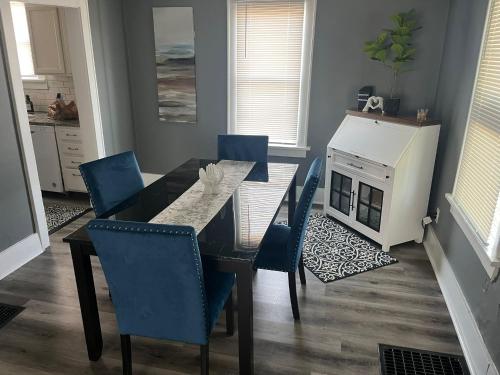 a dining room with a table and chairs and a fireplace at A-Frame Charmer in Town, Newly Renovated in LaPorte