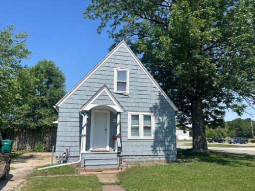 a small blue house with a white door at A-Frame Charmer in Town, Newly Renovated in LaPorte