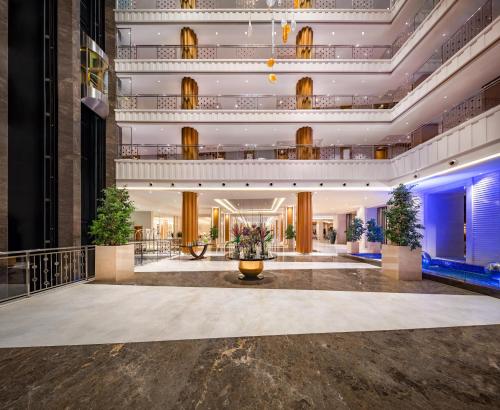 a lobby of a hotel with a large building at Trendy Lara in Lara
