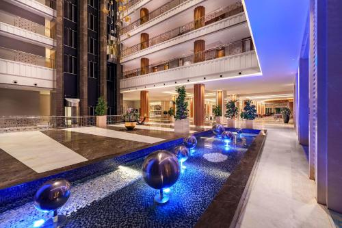 a hotel lobby with a pool in the middle at Trendy Lara in Lara
