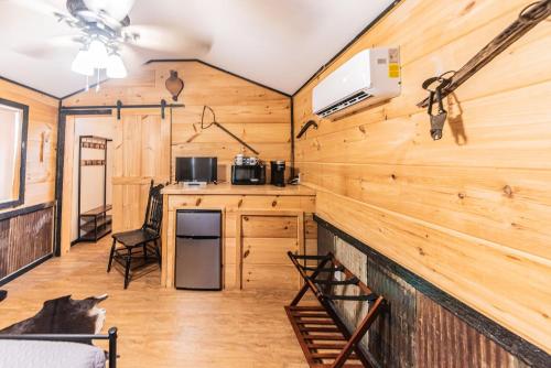 a large room with wooden walls and a kitchen at The Outpost in Grand Rivers