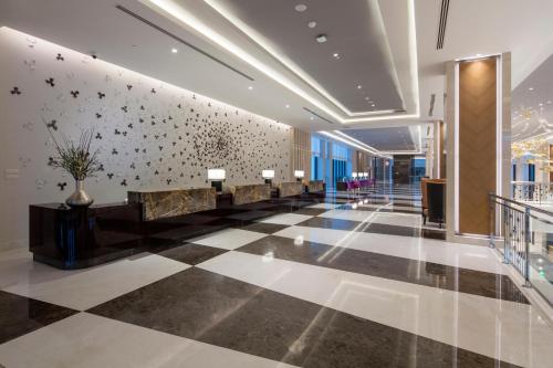 a lobby of a building with a wall with flowers on it at Trendy Lara in Lara
