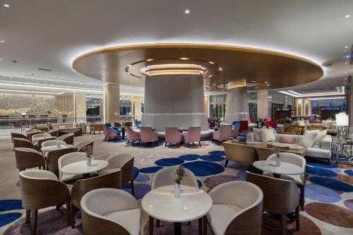 a lobby of a hotel with tables and chairs at Trendy Lara in Lara