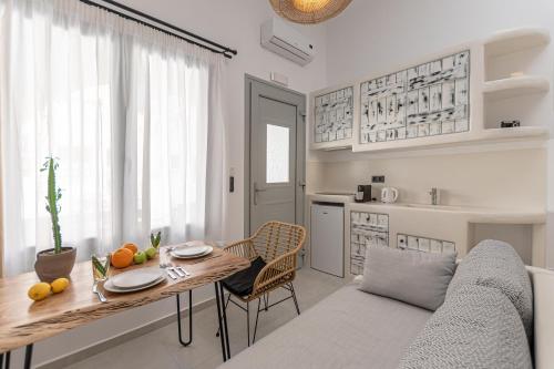 a kitchen and living room with a table and a couch at Adama's Suites in Naxos Chora