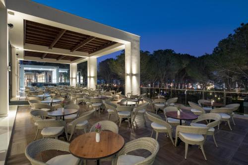a restaurant with tables and chairs at night at Trendy Lara in Lara