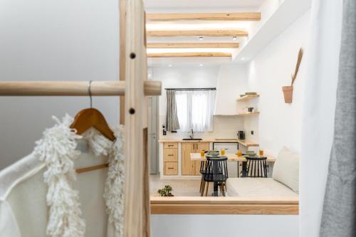 a small kitchen and dining room with a table and chairs at Adama's Suites in Naxos Chora