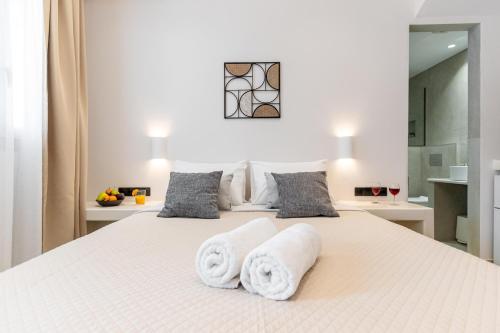 a bedroom with two towels on a bed at Adama's Suites in Naxos Chora