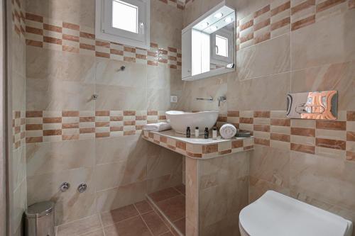 a bathroom with a sink and a shower at Adama's Suites in Naxos Chora