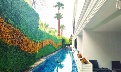 a swimming pool with a mural of a sunflower wall at Side Zeugma Hotel - Adult Only 16 Plus in Side