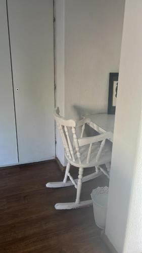 a white rocking chair in a room with a table at Peaamb GuestHouse - Springs Golf Club in Springs