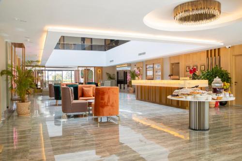 a lobby of a hotel with a reception desk and chairs at Side Zeugma Hotel - Adult Only 16 Plus in Side