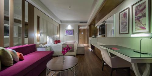 a living room with a purple couch and a table at Trendy Lara in Lara