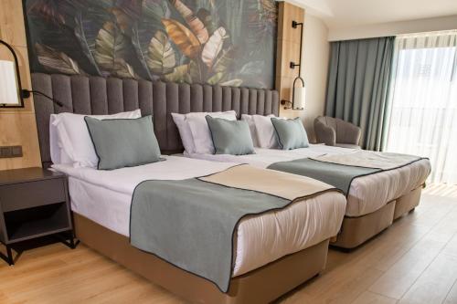 a hotel room with two beds in a room at Side Zeugma Hotel - Adult Only 16 Plus in Side