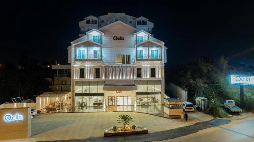 a large white building with a sign in front of it at Q Ella Beach Hotel in Side