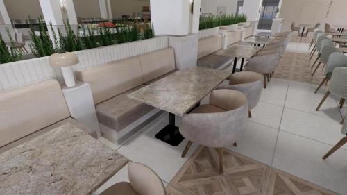 a row of tables and chairs in a restaurant at Q Ella Beach Hotel in Side