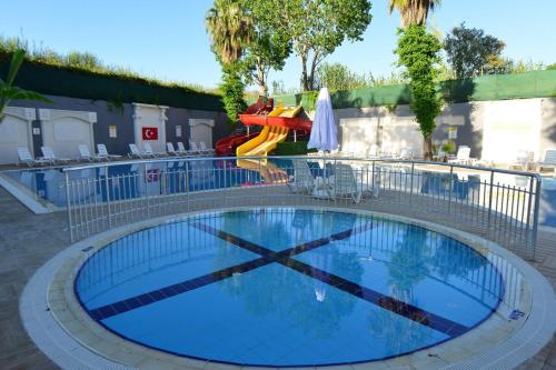 a swimming pool with a slide and a playground at Q Ella Beach Hotel in Side