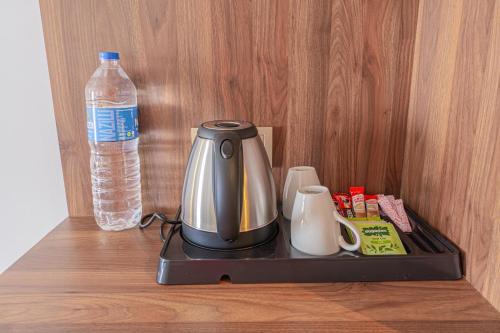 a coffee maker on a tray next to a bottle of water at Q Ella Beach Hotel in Side