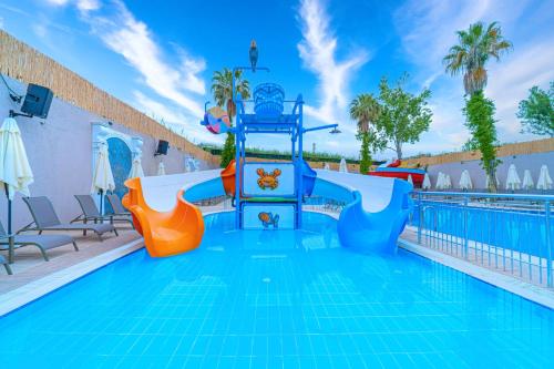 a pool with a water slide in a resort at Q Ella Beach Hotel in Side