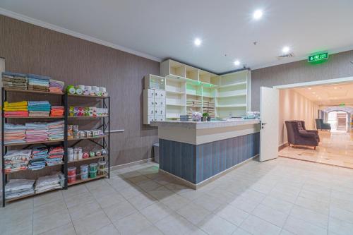 a store lobby with a counter and a chair at Q Ella Beach Hotel in Side