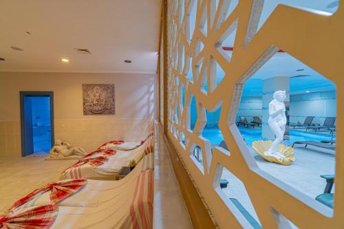 a kids room with a swimming pool and a slide at Q Ella Beach Hotel in Side