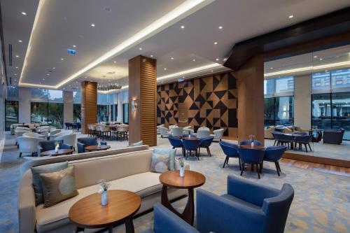 a lobby of a hotel with tables and chairs at Trendy Lara in Lara