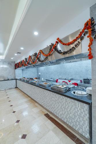 a kitchen with a counter with a bunch of dishes at Q Ella Beach Hotel in Side