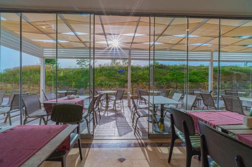 a restaurant with tables and chairs and a view at Q Ella Beach Hotel in Side