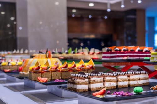 a buffet with many different types of cakes and desserts at Trendy Lara in Lara