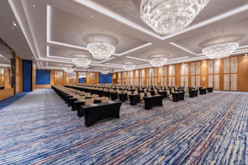 a large room with rows of chairs and chandeliers at Trendy Lara in Lara
