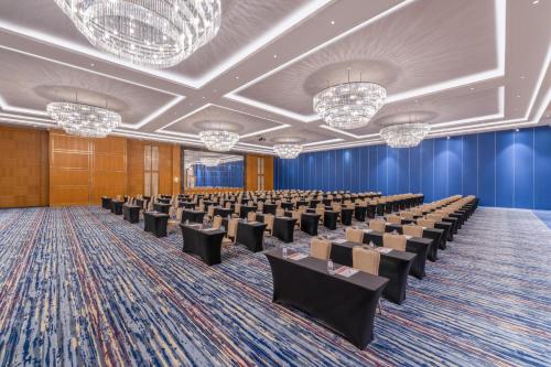 a large room with rows of chairs and chandeliers at Trendy Lara in Lara