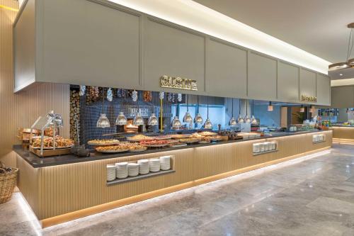 a bakery with a buffet of food on display at Kirman Belazur Resort & Spa in Belek