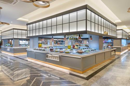 a food court in a restaurant with a buffet at Kirman Belazur Resort & Spa in Belek