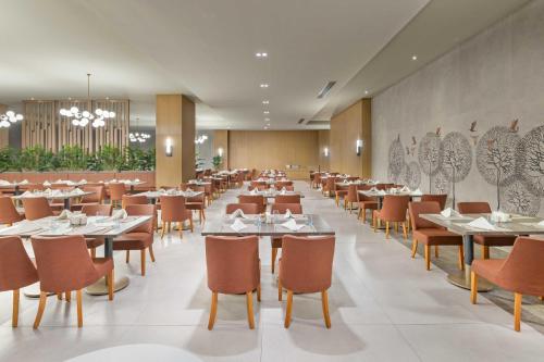 a dining room filled with tables and chairs at Kirman Belazur Resort & Spa in Belek
