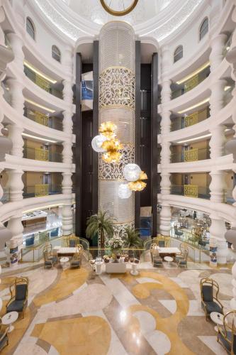 a lobby of a hotel with tables and chairs at Kirman Belazur Resort & Spa in Belek