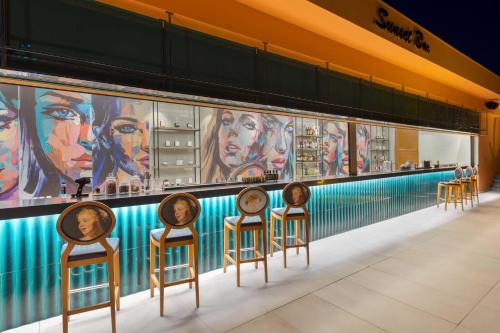 a row of chairs in front of a wall with paintings at Kirman Belazur Resort & Spa in Belek