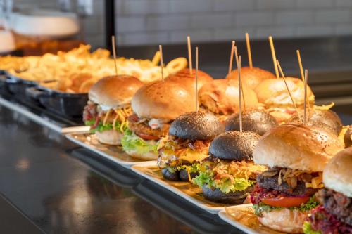 a bunch of sandwiches on trays in a buffet at Kirman Belazur Resort & Spa in Belek