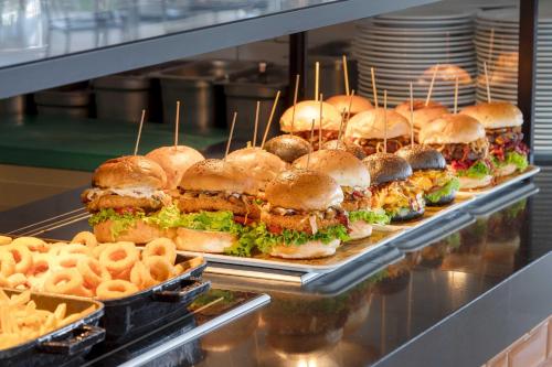 a bunch of sandwiches and fries in a display case at Kirman Belazur Resort & Spa in Belek