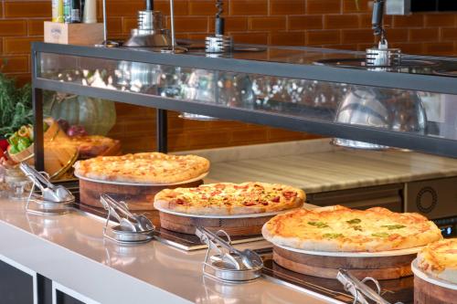 four pizzas sitting on a counter in a kitchen at Kirman Belazur Resort & Spa in Belek