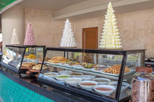 a buffet of food with christmas trees in the background at Kirman Belazur Resort & Spa in Belek