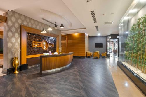a lobby with a bar in the middle of a building at Kirman Belazur Resort & Spa in Belek