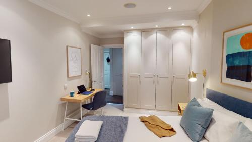 a bedroom with a bed and a desk with a laptop at Madison Hill - White Hill House 3 - 1 bedroom flat in London