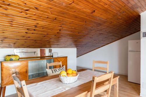 a kitchen with a table with a bowl of fruit at Italian Experience-Sopraloreto Apartment in Loreto