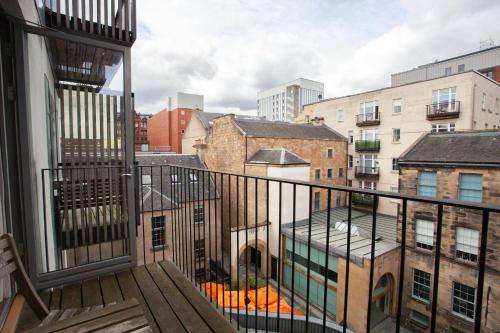 a balcony with a view of a city at Stylish 3rd Floor Flat in Historic Merchant City in Glasgow